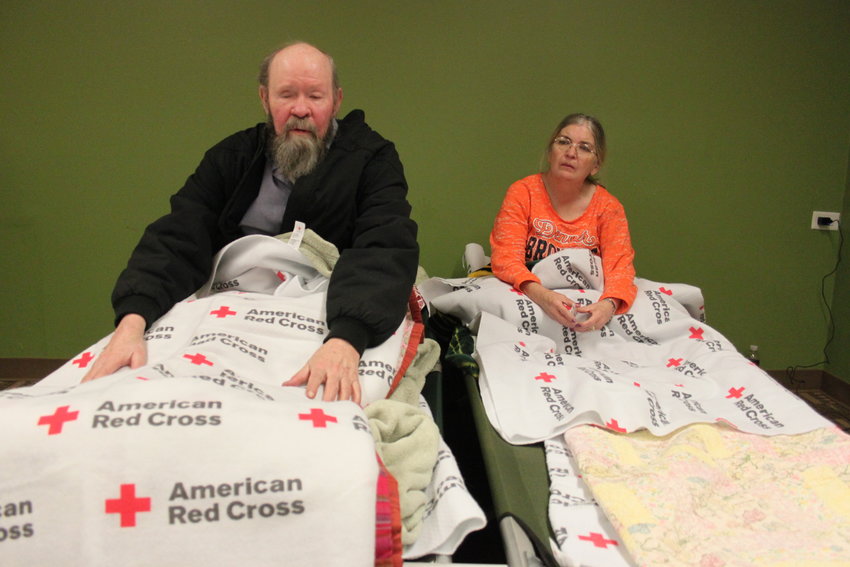 Ray Hays, left, and his caretaker Carla Baker spent the night on cots in a Red Cross shelter after a fire forced them out of the Windermere apartments on Nov. 17. Hays, who is blind and half deaf, returned to the complex after being evicted following a 2016 fire. Photo by David Gilbert